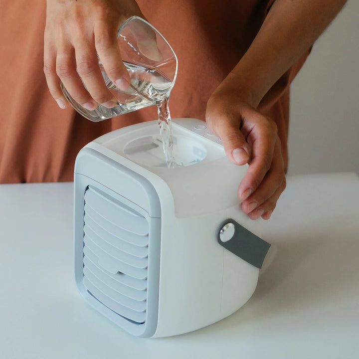 Individual filling water in the white and grey air cooler